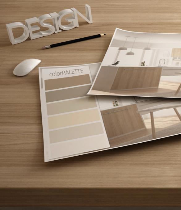 Two kitchen designers work on kitchen plans in a showroom, surrounded by material samples and measuring tools. Custom kitchen design and layout.